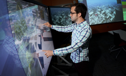 Student reviewing GIS information on a large screen