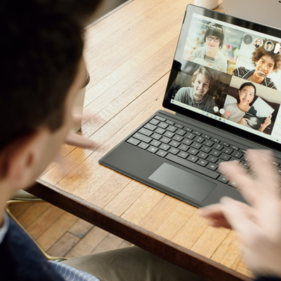laptop computer showing four people in an online meeting