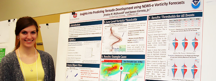 Minnesota State undergraduate student with scholarly research poster